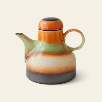 The HKLIVING 70s Ceramics Coffee Pot - Morning features a rounded ceramic design with a large handle, short spout, and lid. Its retro look showcases orange, green, cream & brown horizontal bands on a light background, inspired by the 70s.