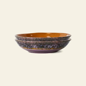 The HKliving 70s Ceramics: Curry Bowls, Set of 2 features a glossy brown interior and textured dark purple-black exterior, capturing retro charm against a plain background.
