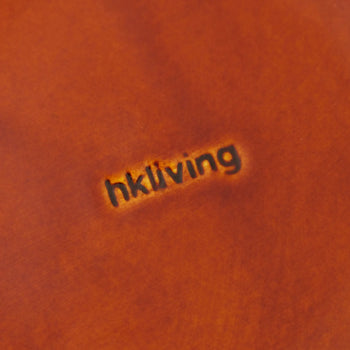 A close-up of HKliving’s 70s Ceramics Curry Bowls (set of 2) highlights the brand name, evoking a vintage feel through the warm brown finish and subtle logo impression.