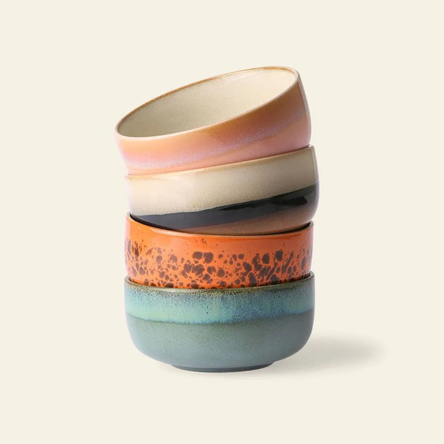 The HKLIVING 70s Ceramics Dessert Bowls, Set of 4, features earth-toned patterns—speckled orange, smooth teal, black, and beige—for a charming retro look against a light background.