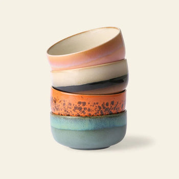 The HKLIVING 70s Ceramics Dessert Bowls, Set of 4, features earth-toned patterns—speckled orange, smooth teal, black, and beige—for a charming retro look against a light background.