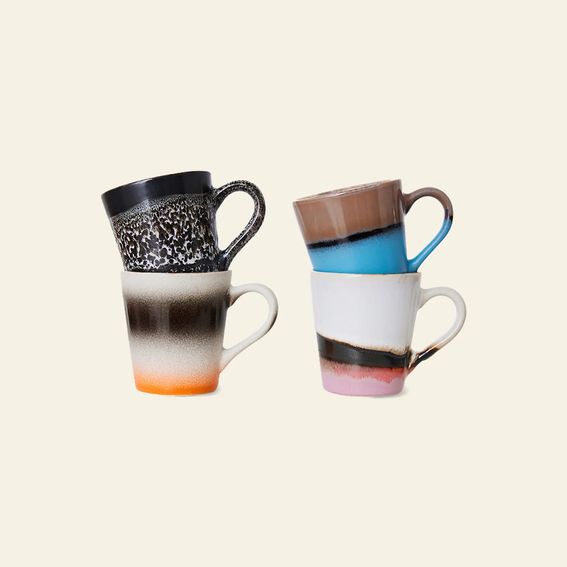 HKLIVING 70s Ceramics: Espresso Mugs, Set of 4—colorful mugs with black, brown, orange, blue, white & pink designs—are stacked in two uneven piles on a plain light beige background.