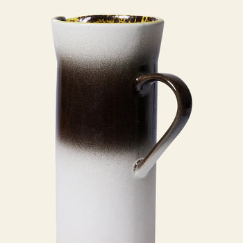 The HKLIVING 70s Ceramics: Jug - Bomb is a tall ceramic pitcher with a curved handle and a dark brown to white gradient, making it a modern accent inspired by 70s ceramics. Brand: HKLIVING.