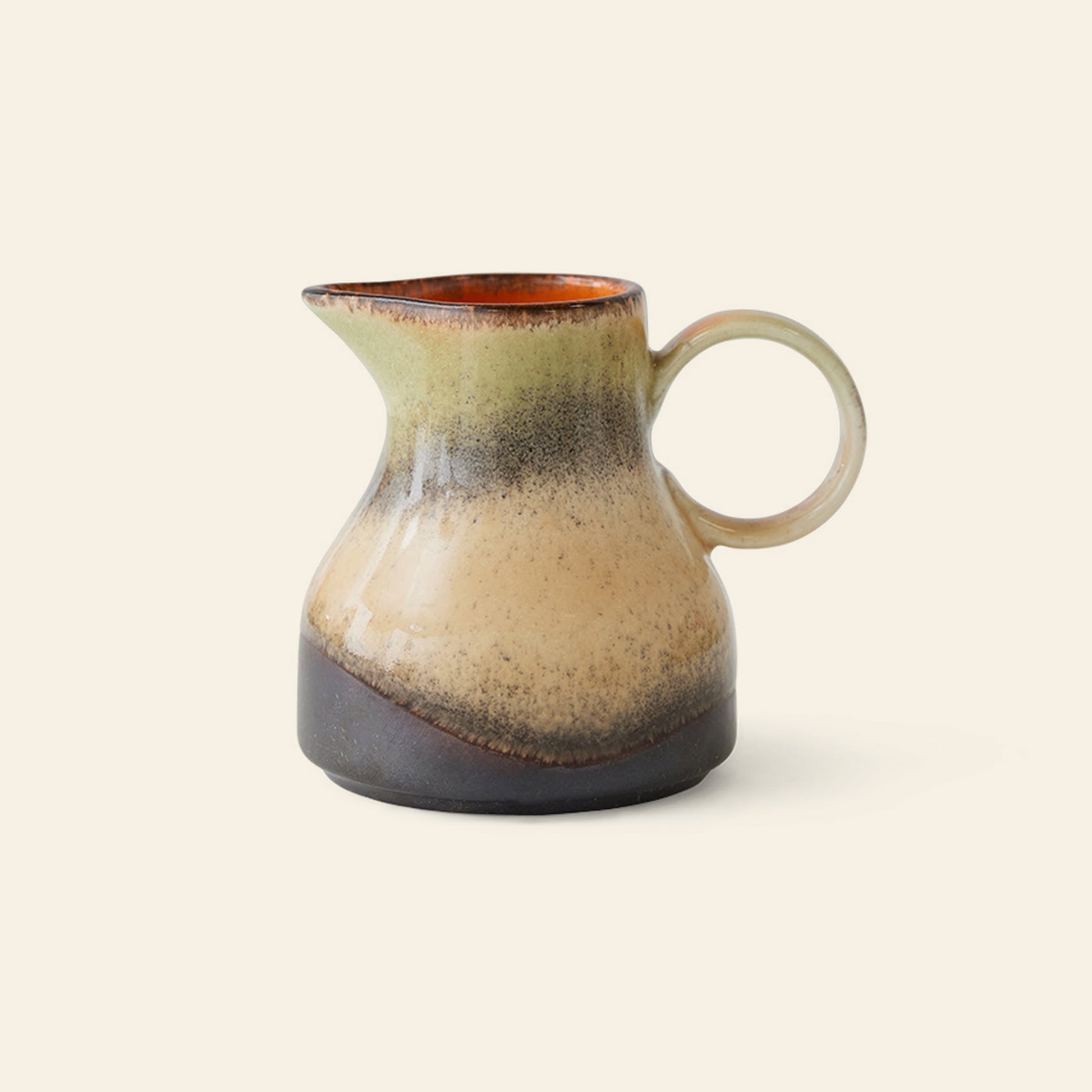 The HKLIVING 70s Ceramics: Milk Jug - 8AM is a vintage-inspired jug with a rounded body, handle, and narrow spout. It features earthy beige, brown, and dark gray tones with a glossy upper inside edge.