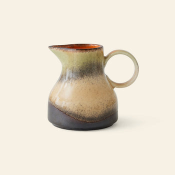 The HKLIVING 70s Ceramics: Milk Jug - 8AM is a vintage-inspired jug with a rounded body, handle, and narrow spout. It features earthy beige, brown, and dark gray tones with a glossy upper inside edge.