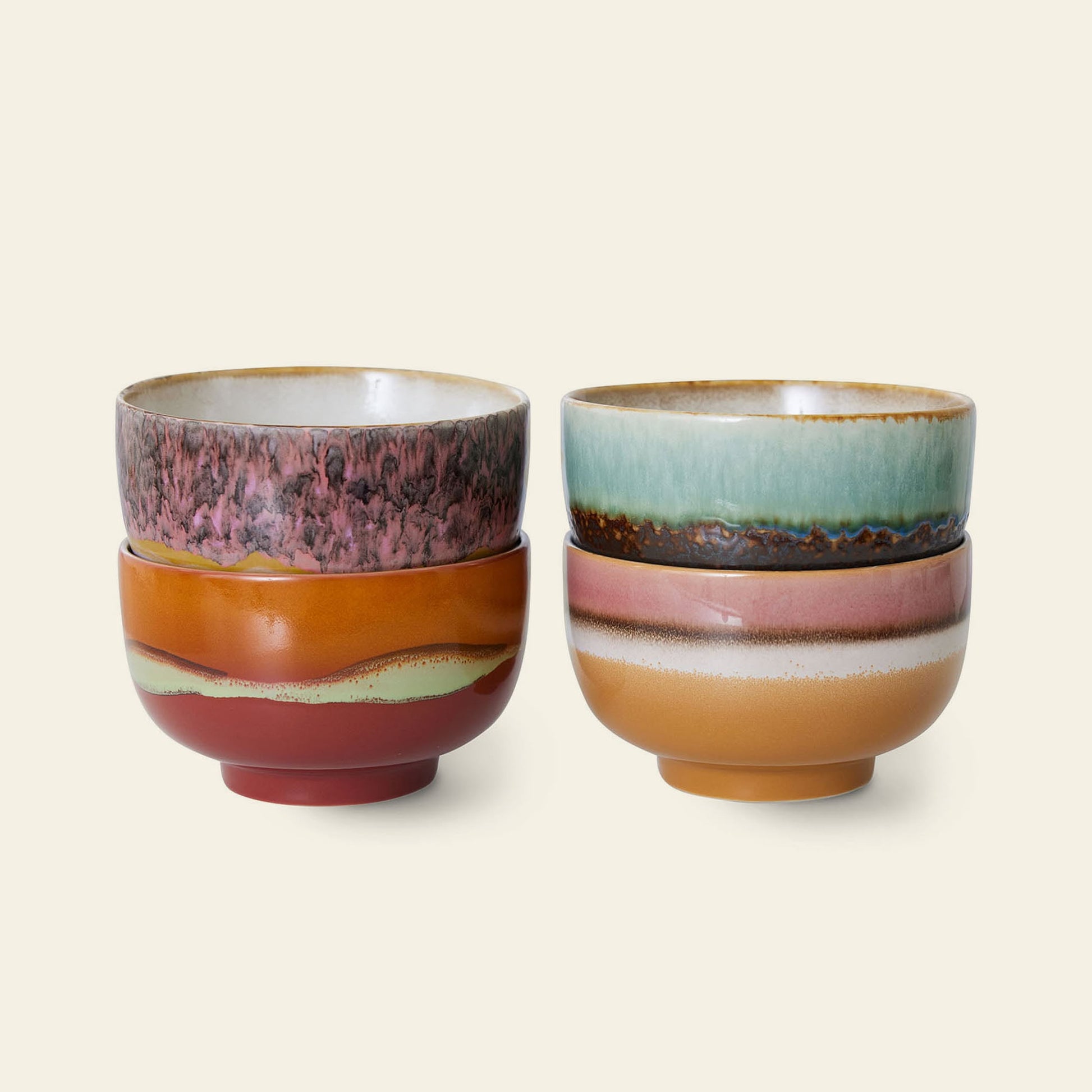 Four HKLIVING 70s Ceramics noodle bowls with colorful, earthy glazes and artistic patterns are stacked in pairs against a plain light background.