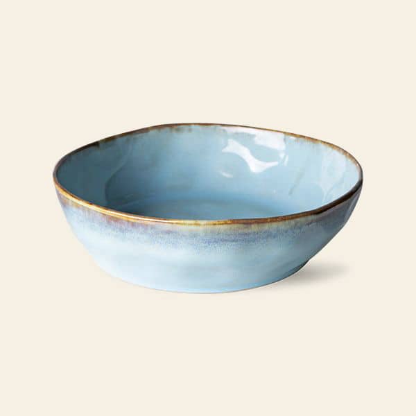 The HKliving 70s Ceramics Pasta Bowls, Set of 2, feature light blue ceramic with brown edging and a slightly irregular shape—ideal for adding elegance to your table setting.