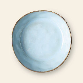 The HKliving 70s Ceramics: Pasta Bowls, Set of 2 features round, light blue ceramic bowls with a slightly uneven surface and rustic brown rims, ideal for an elegant table setting and shown on an off-white background.