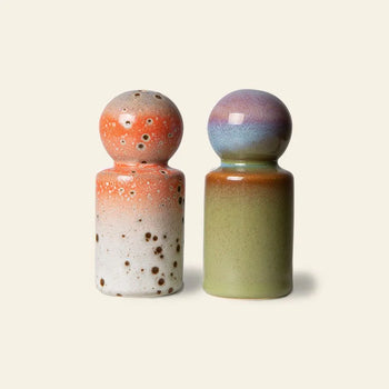 Add a retro touch to your table with HKLIVING 70s Ceramics: Pepper & Salt Jar—two rounded ceramic shakers, one orange and white with brown speckles, the other green with a purple, blue, and orange gradient—by HKLIVING.