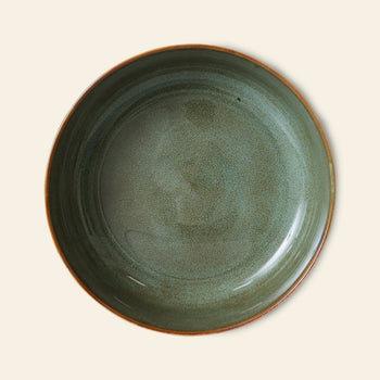The HKLIVING 70s Ceramics: Salad Bowl features a glossy, speckled green ceramic finish with a brown rim, capturing retro charm. Presented on a light beige background.