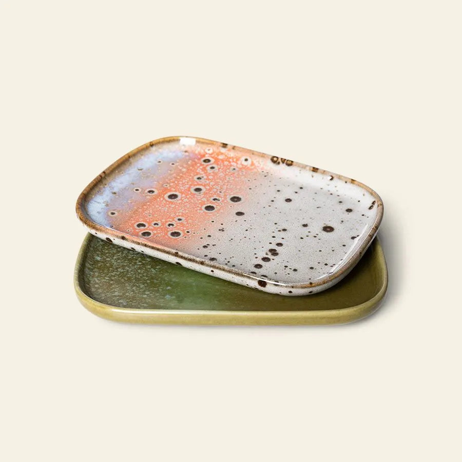 HKLIVING 70s Ceramics: Small Trays, Set of 2 - Atlas features two rectangular trays with rounded edges—a top tray in a speckled white, orange, and brown abstract design and a bottom tray in muted olive green—both with a smooth, retro-inspired finish.