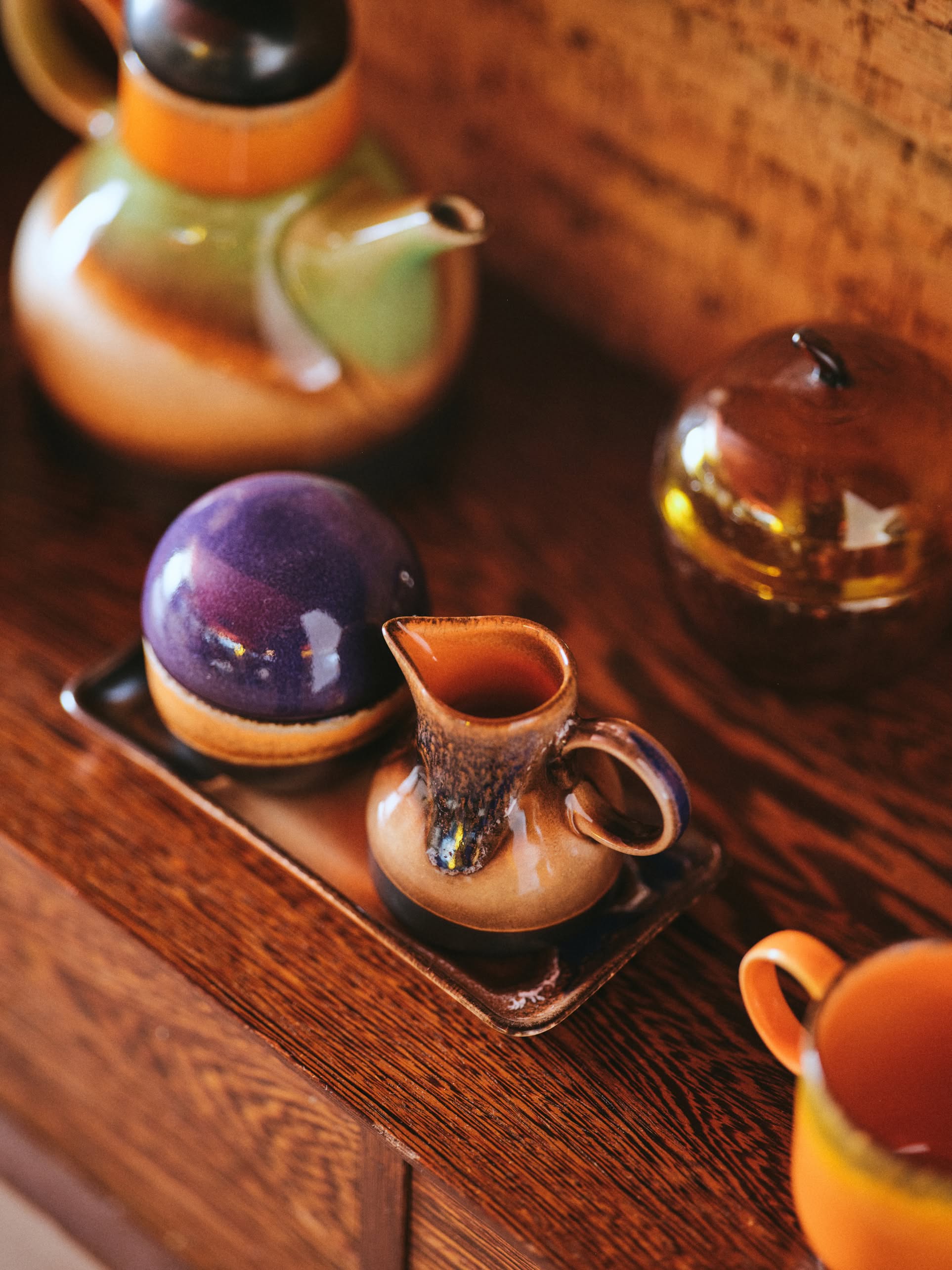 The HKLIVING 70s Ceramics: Small Trays, Set of 2 - Twenty Four Hours features earthy brown, green, orange, and purple tones. These retro small ceramic trays capture the vibrant charm of 70s pottery from the HKLIVING brand.