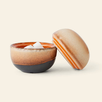 The HKliving 70s Ceramics: Sugar Pot features a round design with a brown and orange gradient glaze. With its lid set aside, it’s perfect for storing sugar cubes, condiments, or sweet treats.