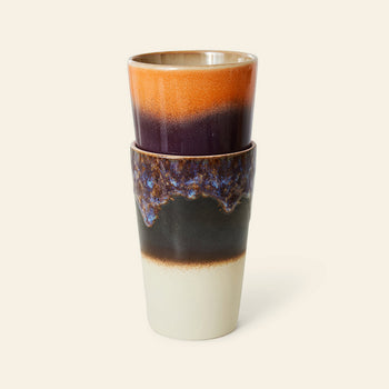 The HKLIVING 70s Ceramics Tea Mugs set includes two retro-inspired mugs: one with an orange and deep purple gradient, the other in blue, brown, and cream with a textured glaze—ideal for fans of vintage ceramics.