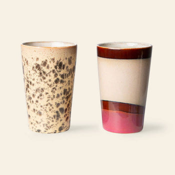The HKliving 70s Ceramics Tea Mugs Set of 2 features two mugs: one with a beige base and dark brown speckles and one with a beige top, dark brown band, and pink bottom. Both HKliving mugs have a smooth, glossy finish.