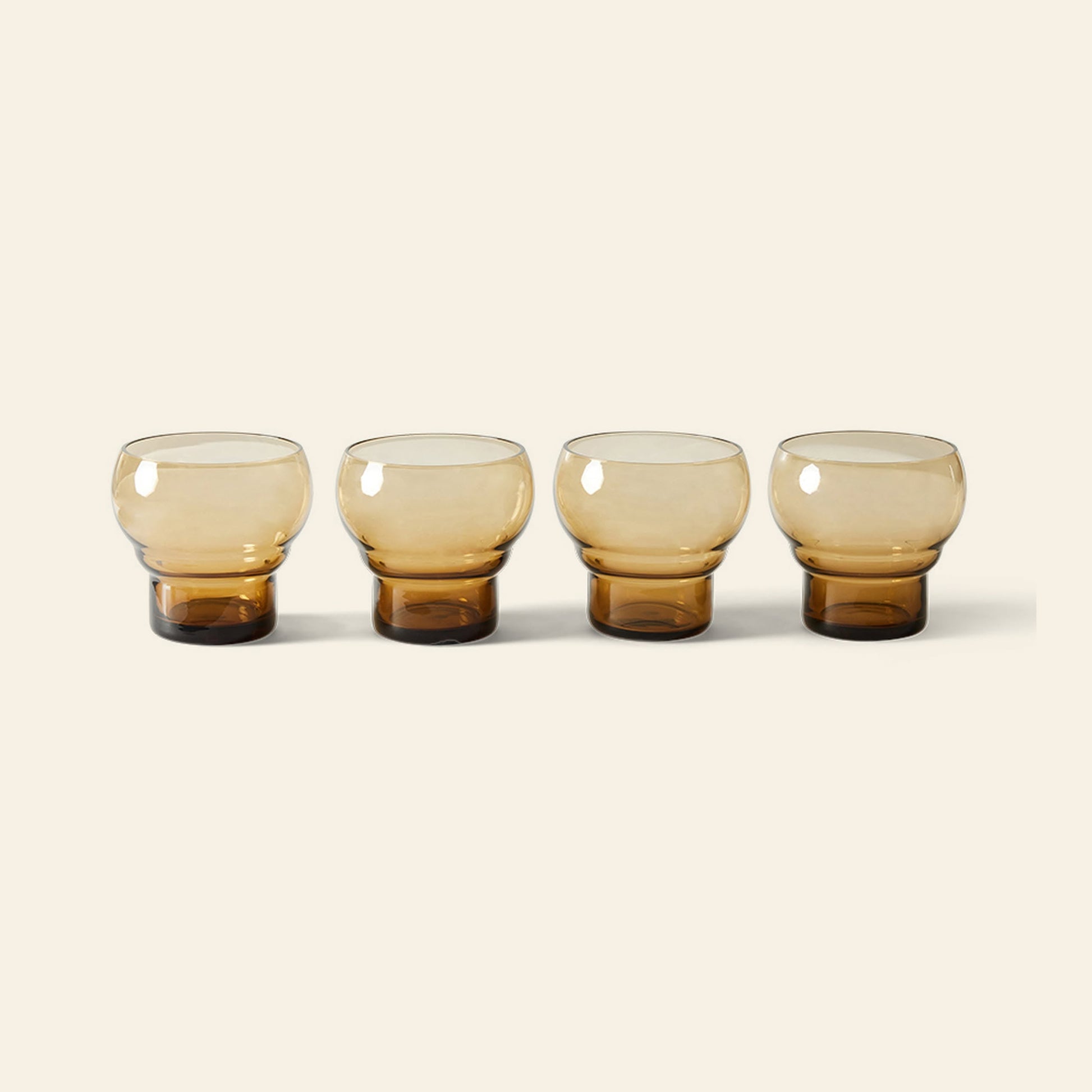 HKLIVING 70s Glassware: Bulb Glasses, Set of 4, features four round amber glasses with thick bases arranged in a row on a light beige background, capturing the retro charm HKLIVING is known for.