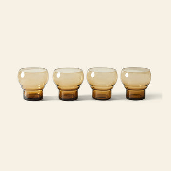 HKLIVING 70s Glassware: Bulb Glasses, Set of 4, features four round amber glasses with thick bases arranged in a row on a light beige background, capturing the retro charm HKLIVING is known for.