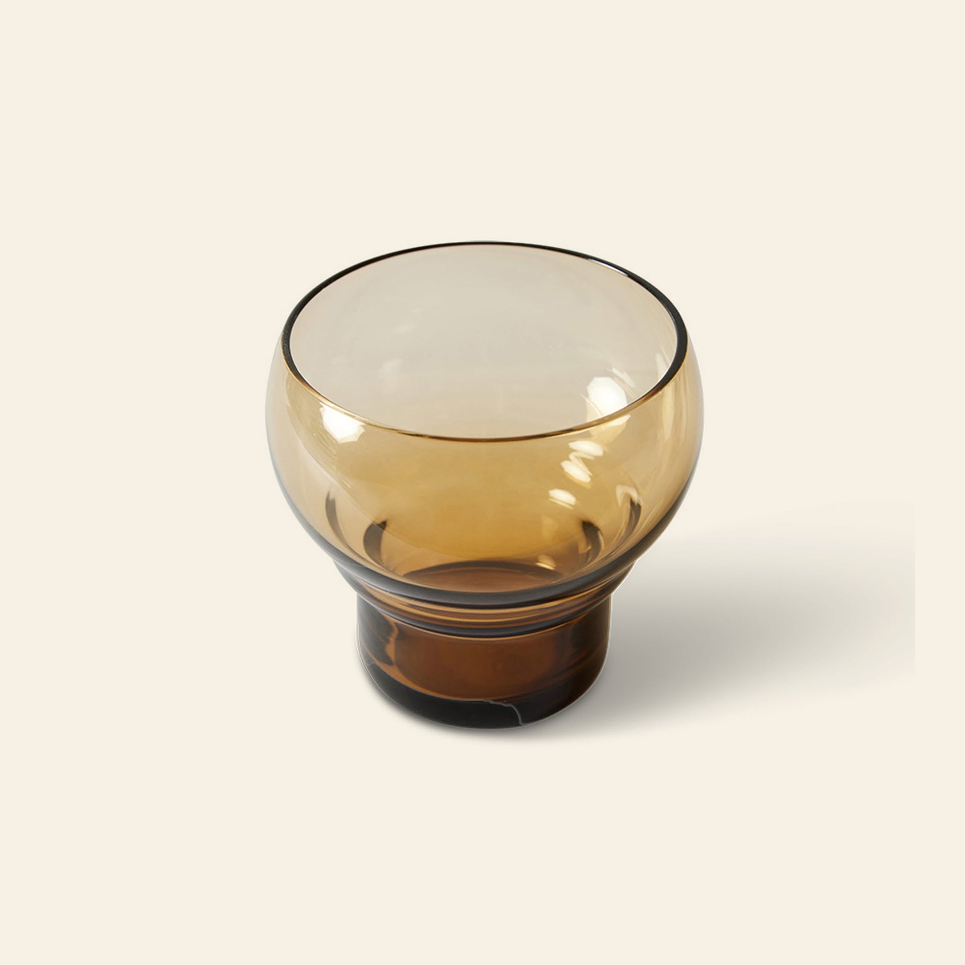 The HKLIVING 70s Glassware: Bulb Glasses, Set of 4 features round, amber-colored glasses with wide openings and short, thick bases, evoking a retro 70s style against a plain light background.