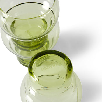 Two HKLIVING 70s Glassware Bulb Glasses, from a set of 4, sit stacked rim-to-rim on a white surface with soft shadows. The upward-facing cup shows the etched HKLIVING logo, echoing retro design.