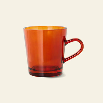 The HKLIVING 70s Glassware Coffee Cups, Set of 4, features translucent amber glass mugs with handles, inspired by vintage 70s design and photographed against a light beige background.
