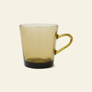 The HKLIVING 70s Glassware Coffee Cups, Set of 4, feature translucent light brown glass with handles, evoking retro 70s style, and are shown against a plain light beige background.