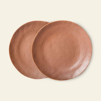 The HKliving Bold & Basic Ceramics Side Plate Set of 2 features round, handcrafted ceramic plates with a smooth matte terracotta finish, overlapping slightly against a light beige background.