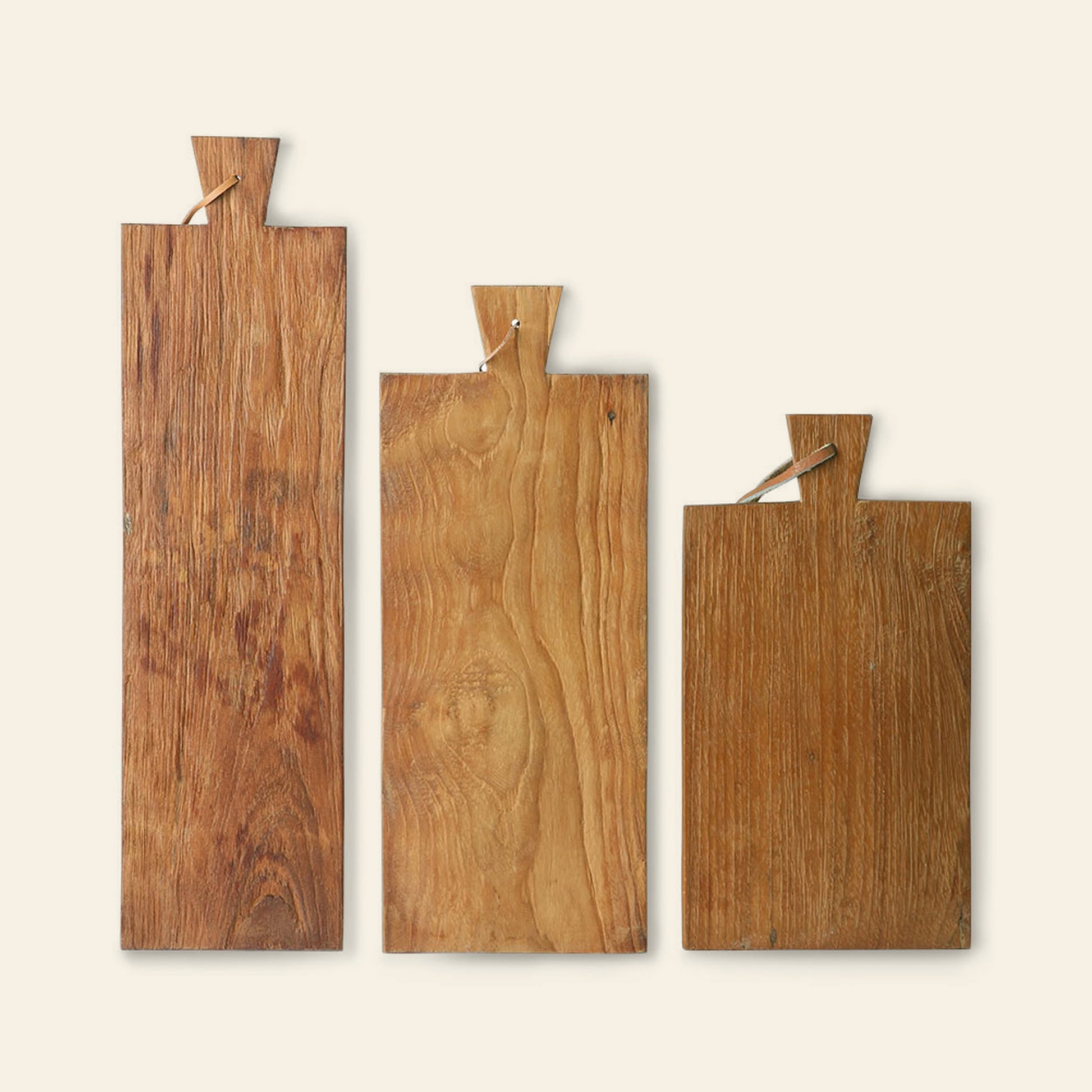 The HKLIVING Bread Board Teak, Set of 3 features three rectangular rustic teak boards in varying sizes, each with a notched handle and string loop, standing upright against a light background.