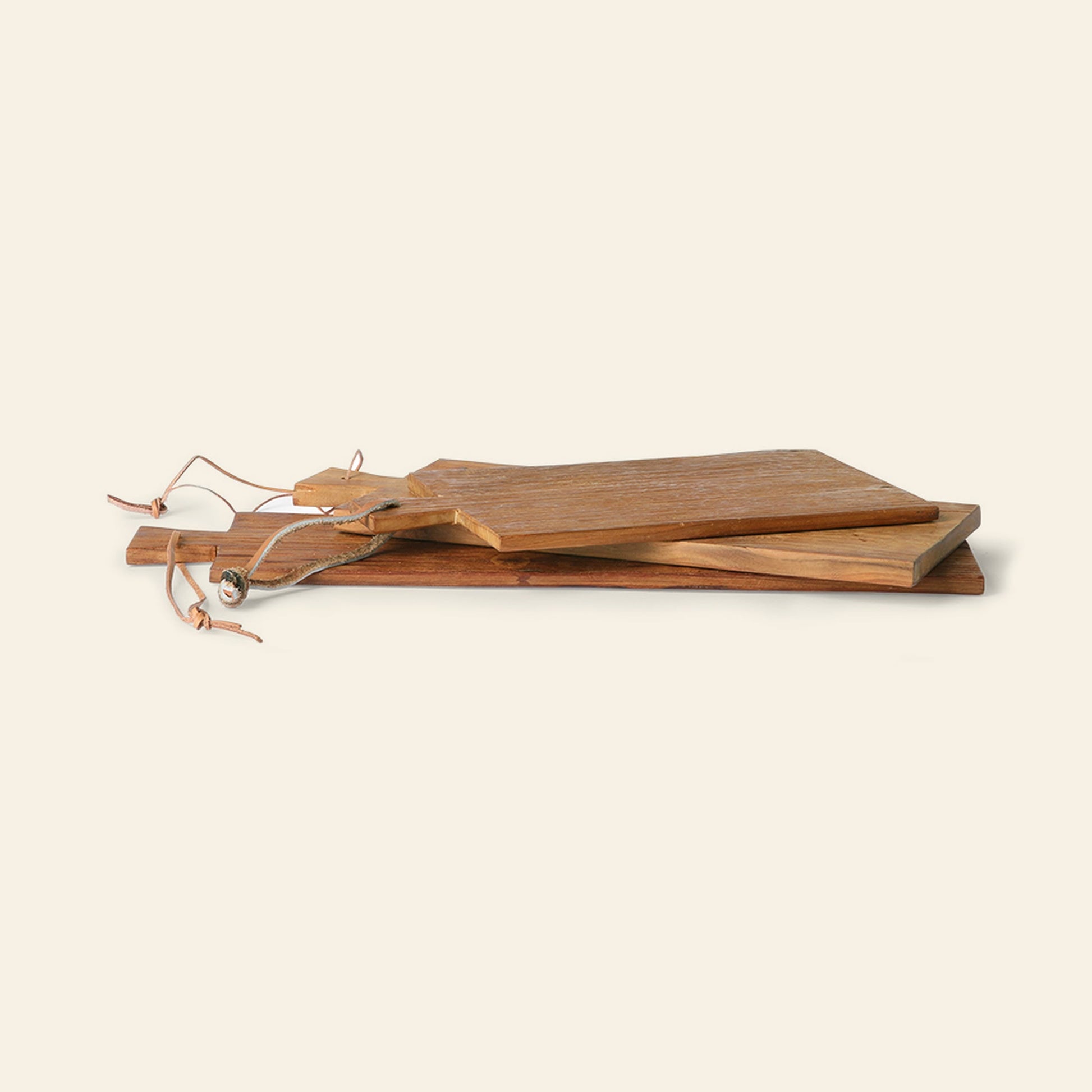 The HKLIVING Bread Board Teak Set of 3 features rustic teak serving boards in varied shapes and sizes, each with a leather hanging loop, all displayed against a plain light background.