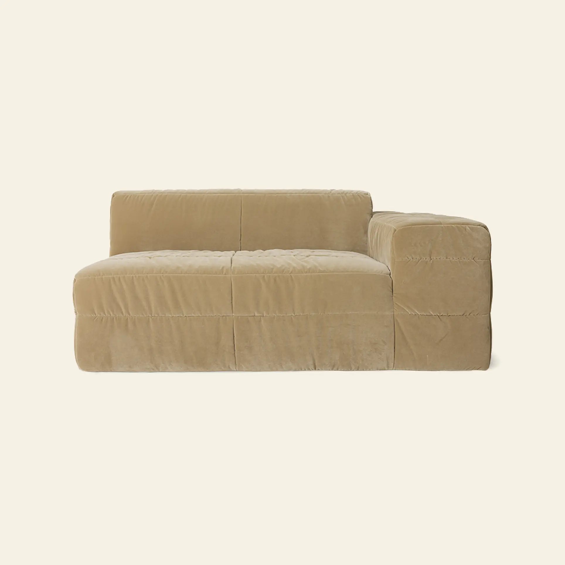 The HKLIVING Brut Sofa, Right by HKLIVING is a modern beige sectional with a low backrest and right-side armrest, upholstered in plush fabric for cozy seating and bold style against a plain off-white background.