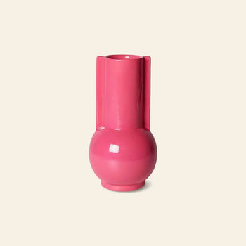 The HKLIVING Ceramic Vase Hot Pink features a glossy finish, round base, and tall cylindrical neck, making a bold accent against a plain light beige background.