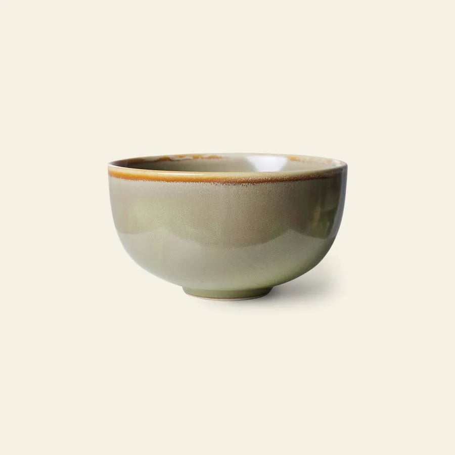 The HKLIVING Chef Ceramics: Bowl by HKLIVING features a smooth, reactive glaze in earthy green and brown tones, with a simple rounded shape and slightly raised base, set against a light beige background.