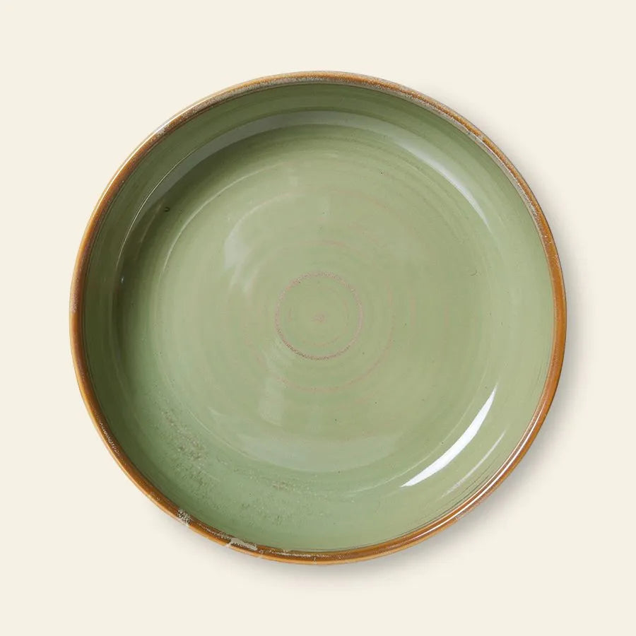 The HKLIVING Chef Ceramics: Deep Plate M is a round, deep plate with a glossy light green interior, brown rim, and hand-glazed unique finish. Photographed from above on an off-white background.