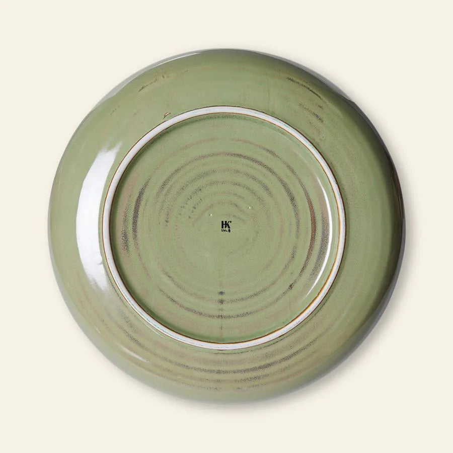 The HKLIVING Chef Ceramics: Deep Plate M is shown upside down on a light background, displaying its round, green hand-glazed ceramic base with circular ridges and a small HK mark at the center.