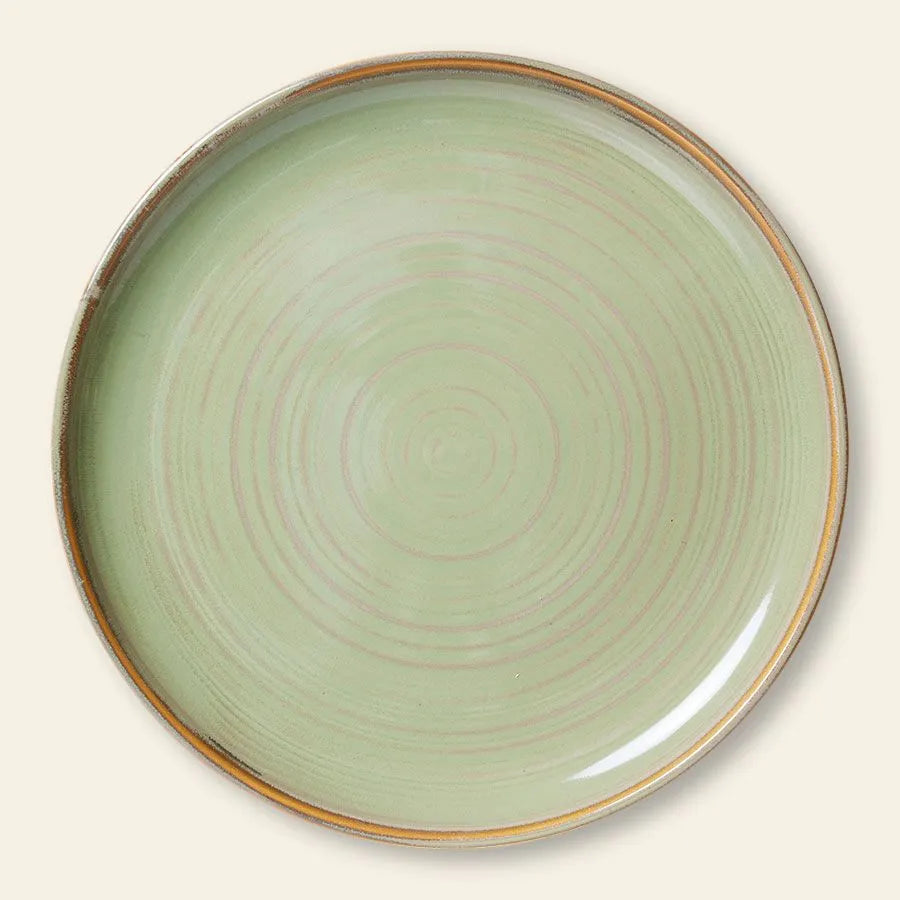 The HKLIVING Chef Ceramics Dinner Plate is round ceramic with a pale green artisanal glaze, concentric circles, and a thin brownish rim, displayed on a light beige background.