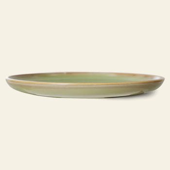 The HKLIVING Chef Ceramics: Dinner Plate is round and shallow, featuring a glossy green artisanal glaze with brown edges, displayed against a plain beige background.