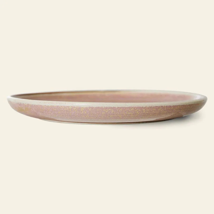 The HKLIVING Chef Ceramics: Dinner Plate is a shallow, round rustic pink plate with a matte, speckled artisanal glaze, shown side-on against an off-white background for a look of subtle elegance.