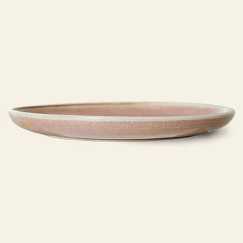 The HKLIVING Chef Ceramics: Dinner Plate is a shallow, round rustic pink plate with a matte, speckled artisanal glaze, shown side-on against an off-white background for a look of subtle elegance.