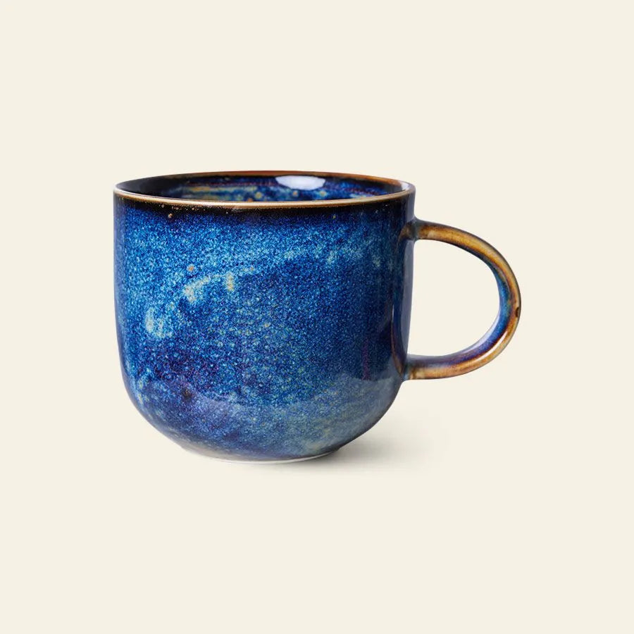 The HKLIVING Chef Ceramics: Mug by HKLIVING features a rounded shape and handle, finished in a glossy blue glaze with varied blue tones, displayed against a plain light background.
