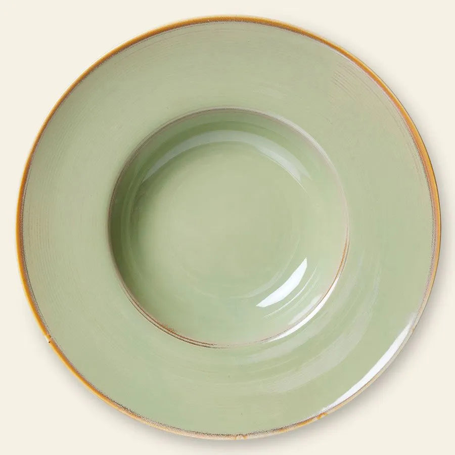 The HKLIVING Chef Ceramics: Pasta Plate by HKLIVING is a round, shallow, pale green handcrafted ceramic plate with a wide rim and thin brownish-gold edge, shown from above on a neutral background.