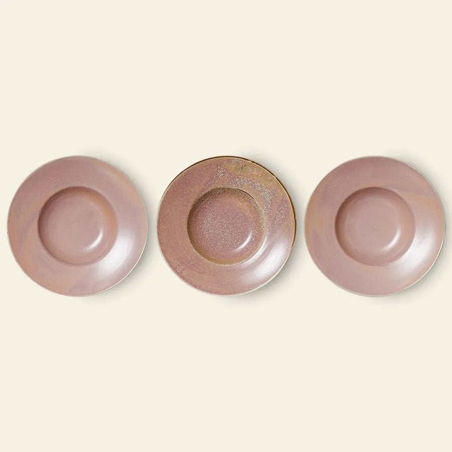 Three round, mauve ceramic plates from HKLIVING are arranged side by side on a light beige background. The center plate is the HKLIVING Chef Ceramics: Pasta Plate, handcrafted with a distinct texture and color pattern.
