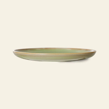 The HKLIVING Chef Ceramics: Side Plate features a shallow, round design with a glossy green hand-glazed finish and subtle brown rim, displayed against a plain light beige background.
