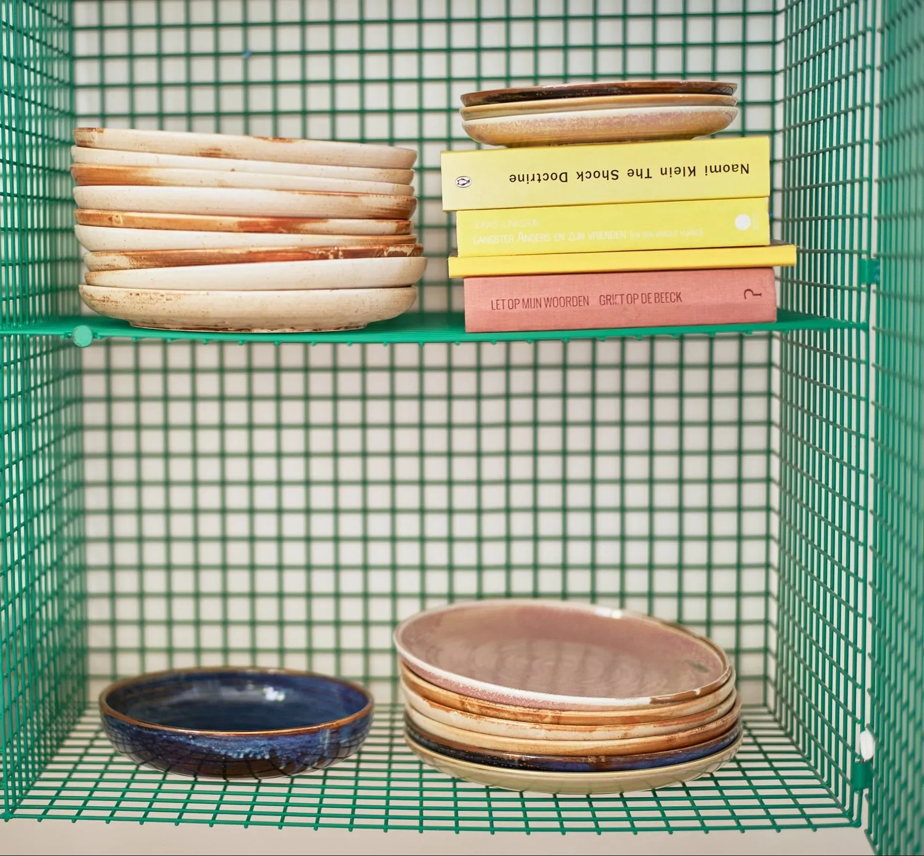 HKLIVING Chef Ceramics: Side Plates by HKLIVING are stacked on both shelves of a green wire rack beside three colorful books, set against a white grid-pattern background.