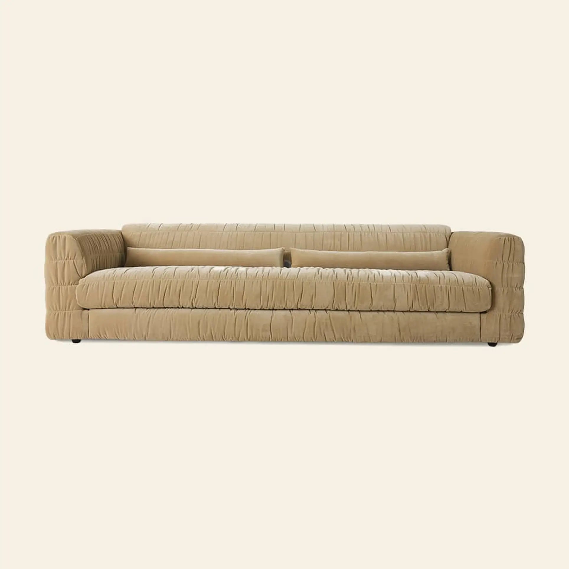 The HKLIVING Club Couch by HKLIVING features deep horizontal tufting, plush cushions, pleated beige upholstery, and low arms—showcasing a contemporary, minimalist look ideal for modern interiors. Set against a plain light background.
