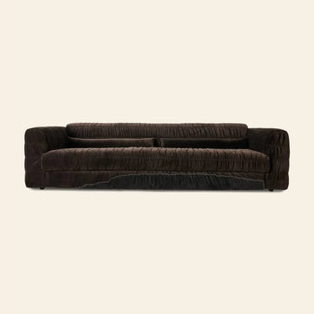 The HKLIVING Club Couch by HKLIVING is a dark brown, low-profile velvet sofa with deep cushions, pleated upholstery, and a ruched textured design, shown against a plain light beige background.