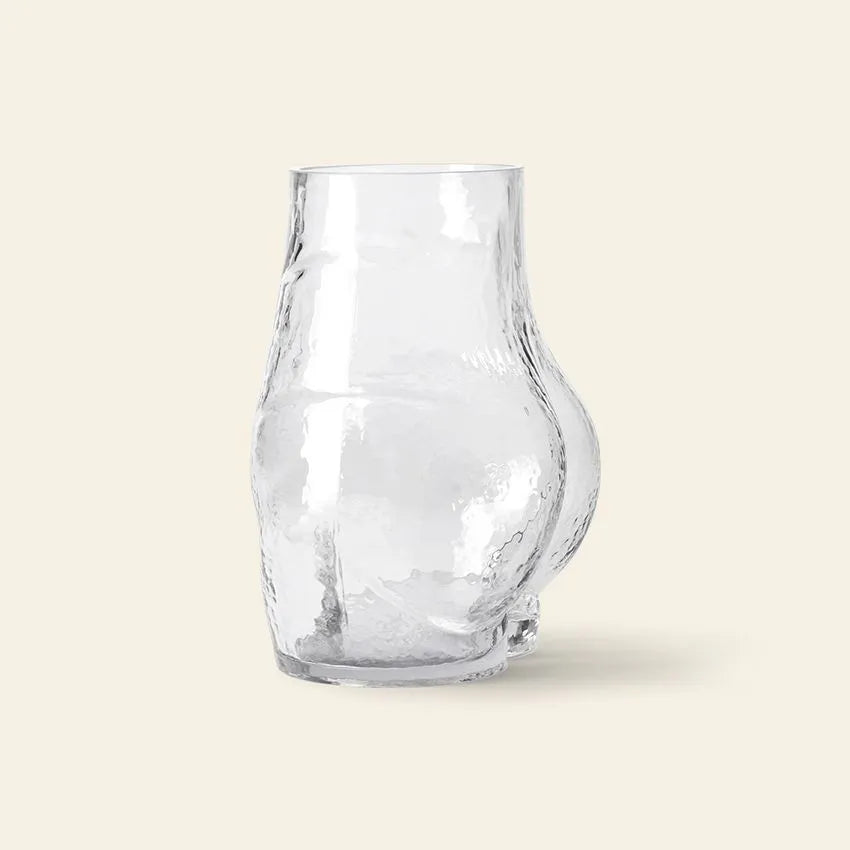 The HKLIVING Glass Bum Vase by HKLIVING features clear glass with an irregular, wavy surface and a prominent rounded bulge on one side, displayed against a plain beige background.