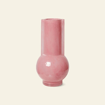 The HKLIVING Glass Vase Flamingo Pink features a tall cylindrical neck and round base, standing out boldly against a plain light beige background.