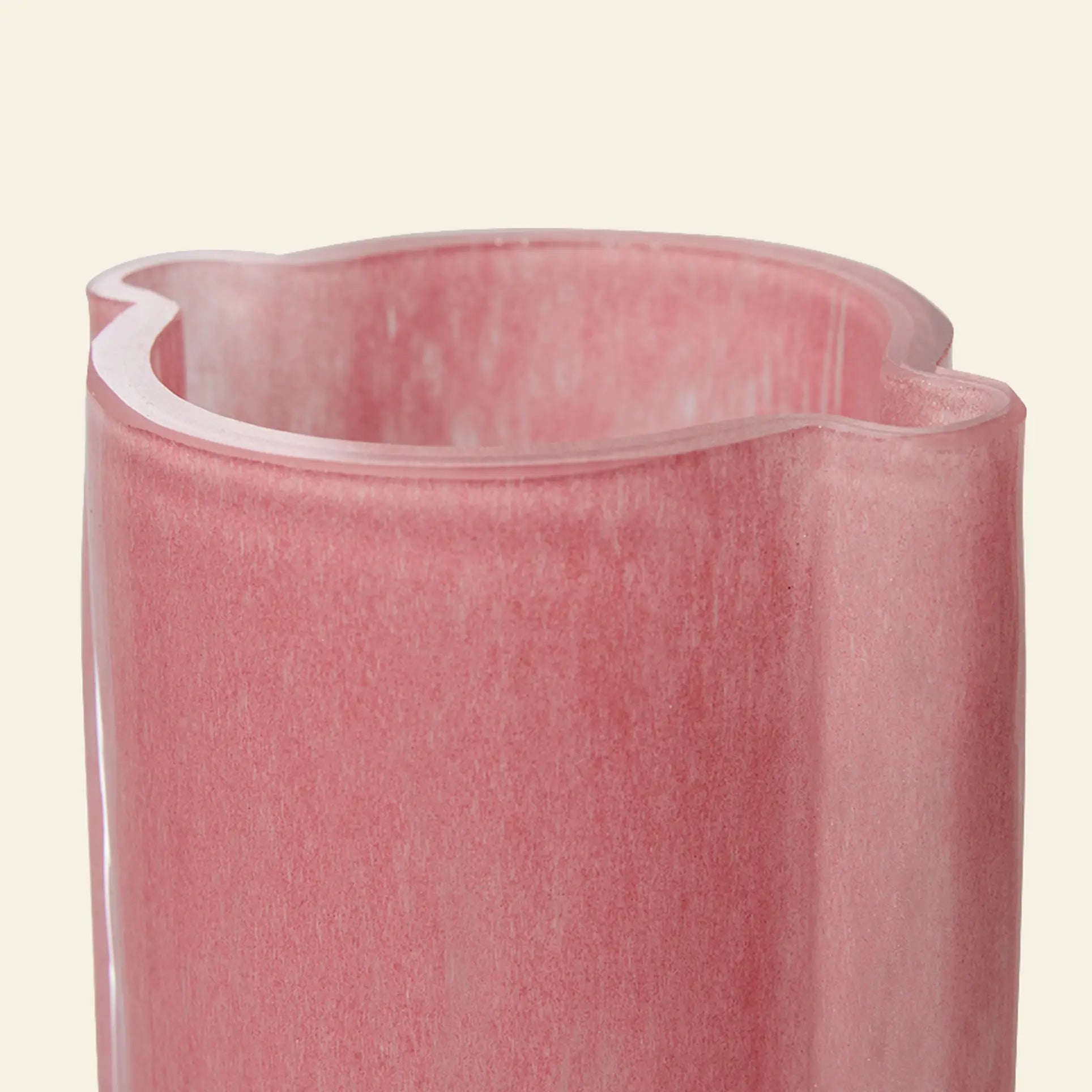 A close-up of the HKLIVING Glass Vase Flamingo Pink, featuring a wavy rim and translucent pink glass, set against a plain light background.