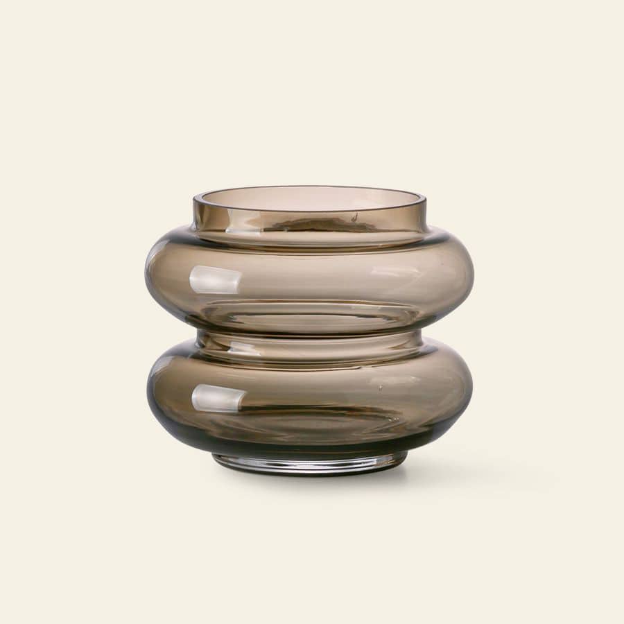 The HKliving Glass Vase S by HKliving features a modern, minimalist bulbous design in smoky brown glass—ideal for enhancing your home decor. Shown against a plain light beige background.