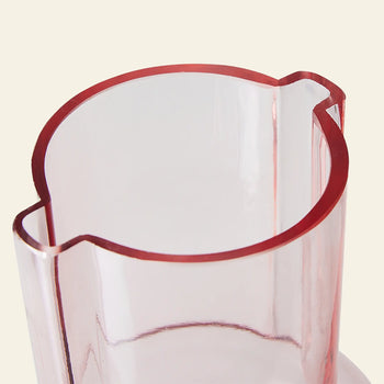 A close-up of the HKLIVING Glass Vase Sundae Pink—a transparent pink vase with a unique wavy rim by HKLIVING—adds contemporary style to any plain background.