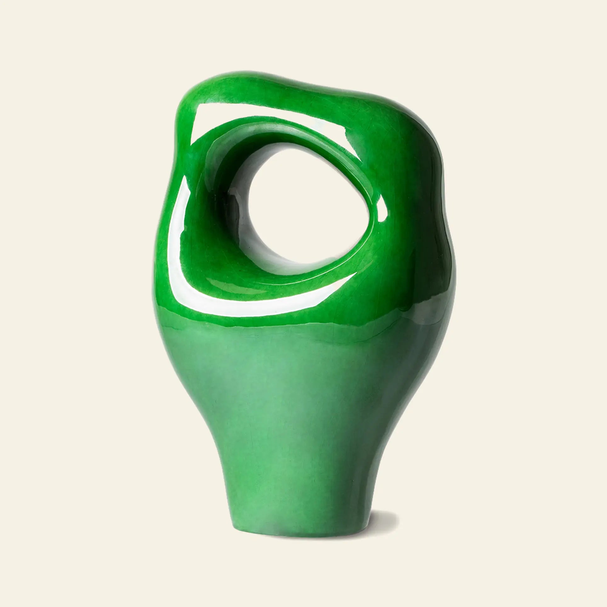 The HKLIVING HK Objects: Ceramic Sculpture by HKLIVING features a glossy abstract green finish, an irregular rounded shape, and a large oval hole near the top—perfect modern home decor displayed against a plain beige background.